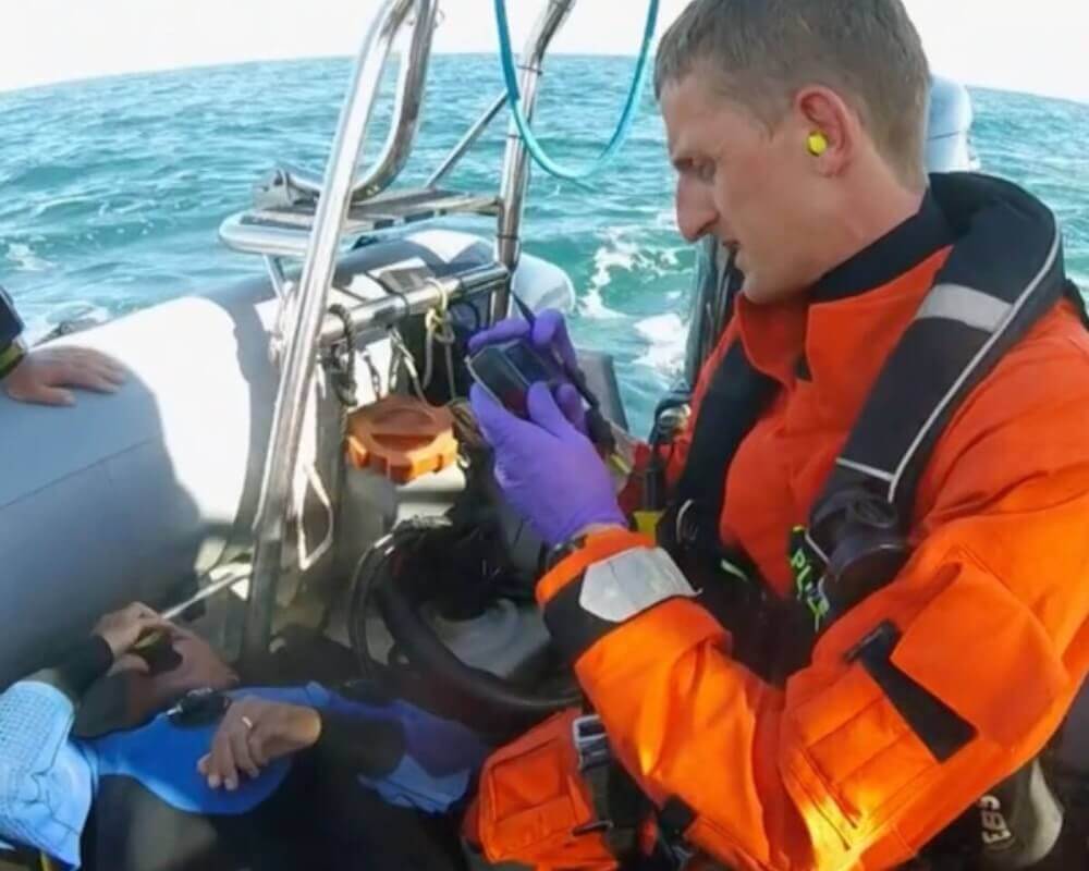 Blog: Shoulder 3. Ollie Moto treating a patient on a boat as part of the Coastguard helicopter search and rescue.